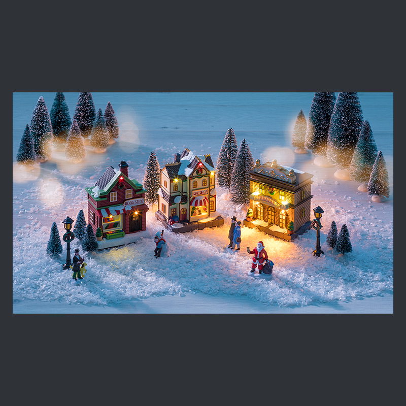 Beleuchtetes Miniaturdorf, Winterabend im Schnee